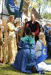Queen Padraigin places Her Crown into the care of Mistress Theodora representing Atlantia's shires. Click here for full size image.