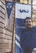 Giuseppe stands in front of a House Corvus war banner. Click here for full size image.